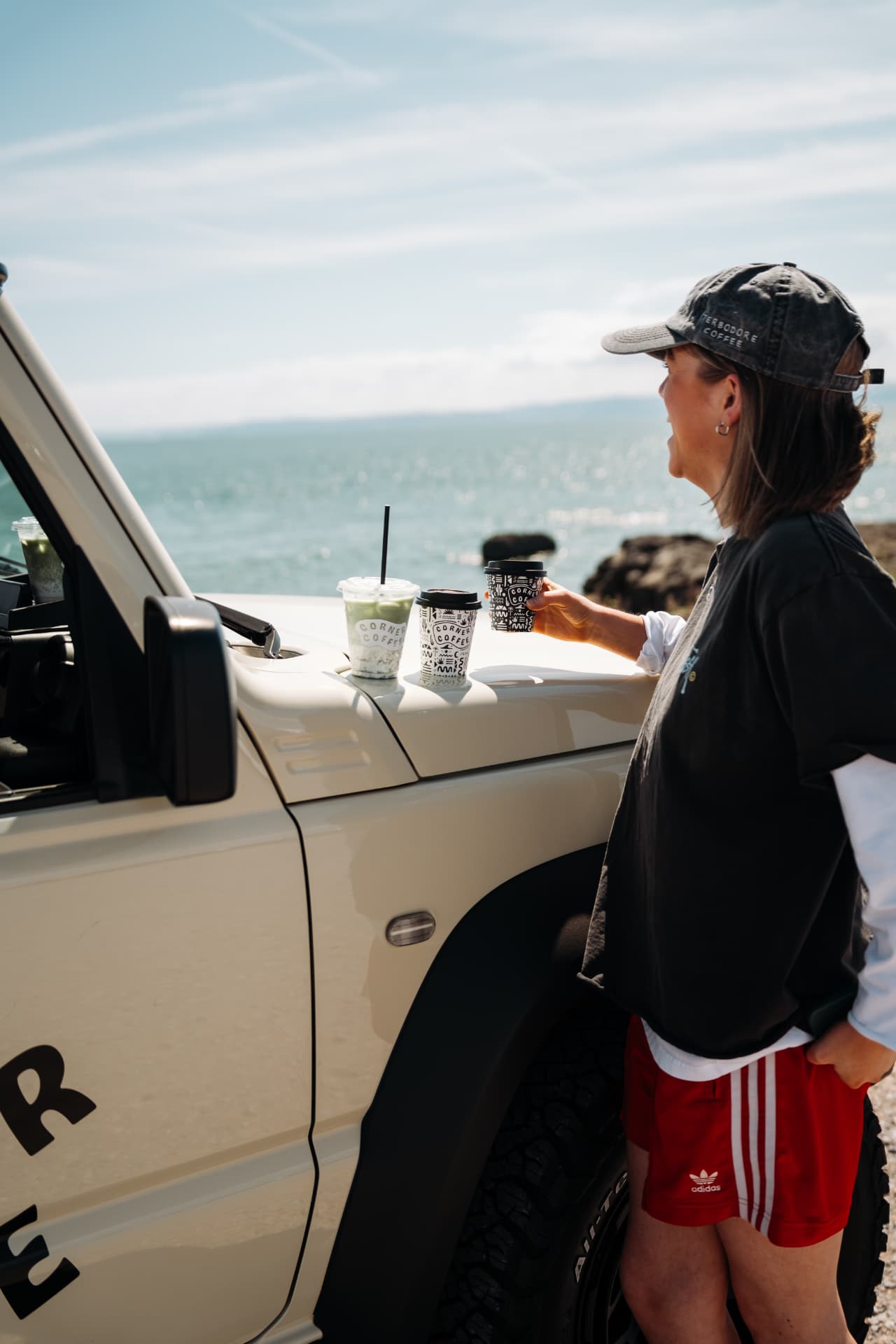 Coffees on the Jimny bonnet by the sea